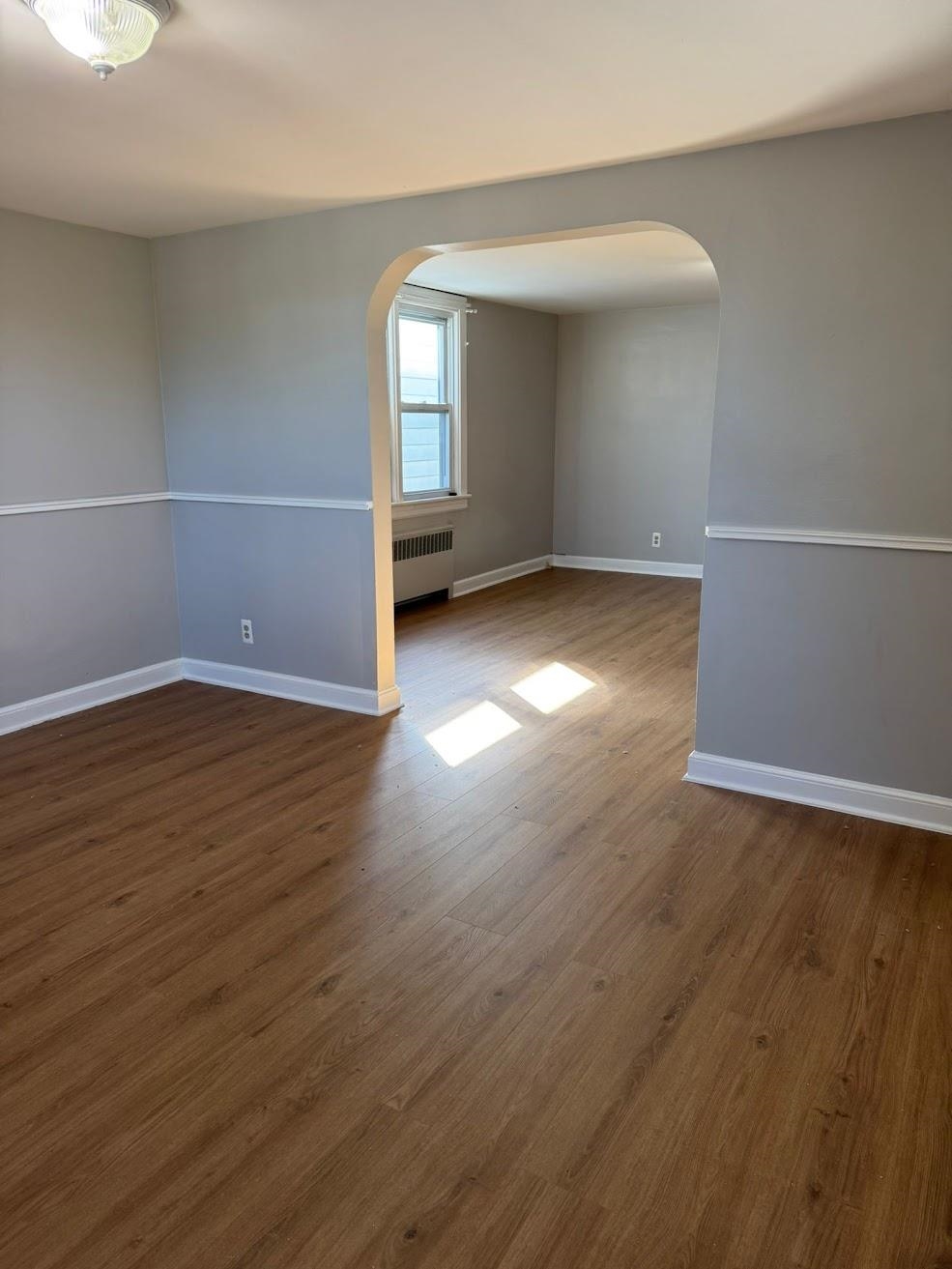 177 Huber Street, Unit 2 Secaucus, NJ 07094 - Photo 4 of 13 an empty room with wooden floor and windows