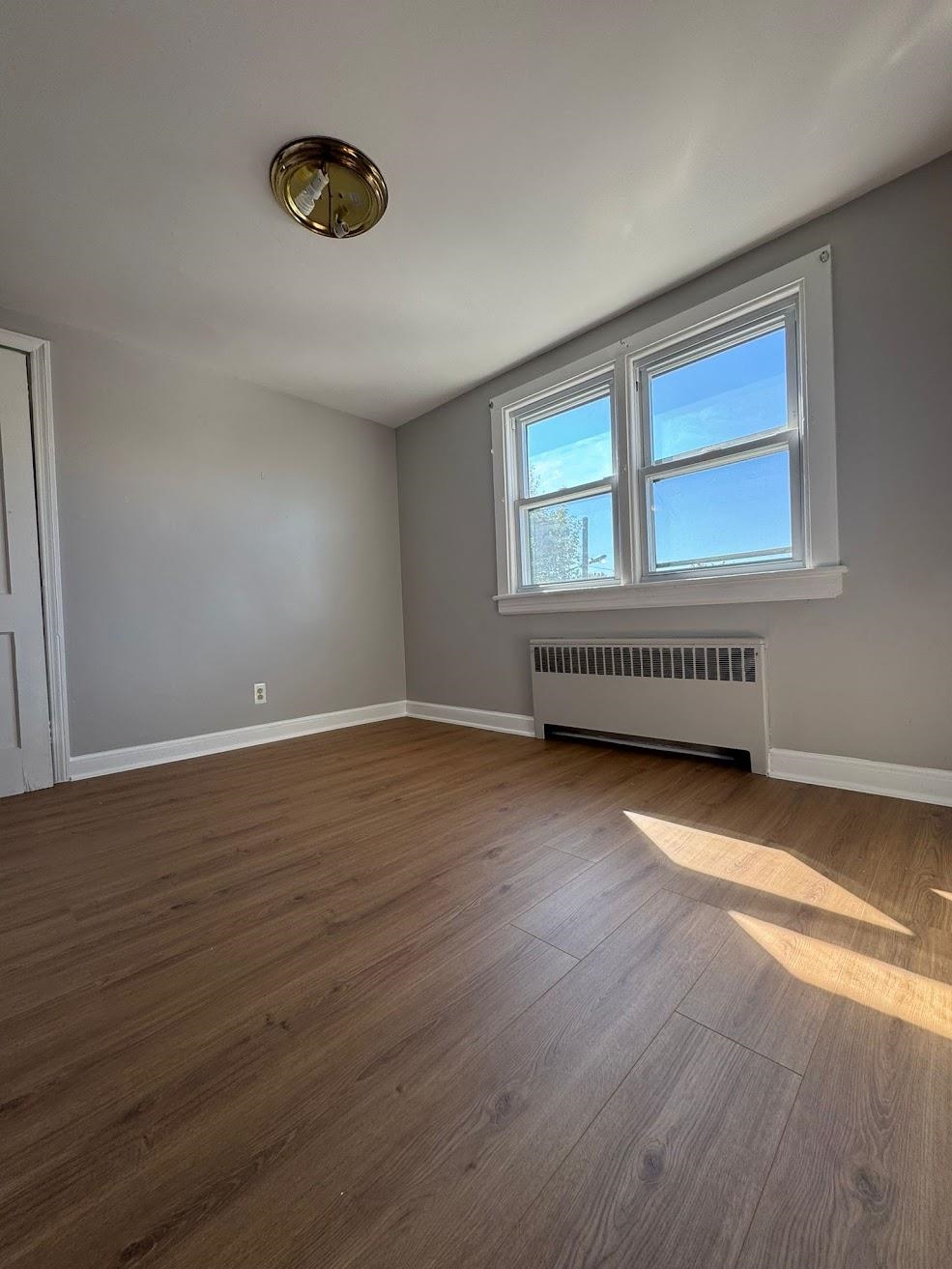 177 Huber Street, Unit 2 Secaucus, NJ 07094 - Photo 9 of 13 a view of a livingroom with wooden floor and a window