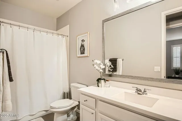 a bed room with a bed and a chair