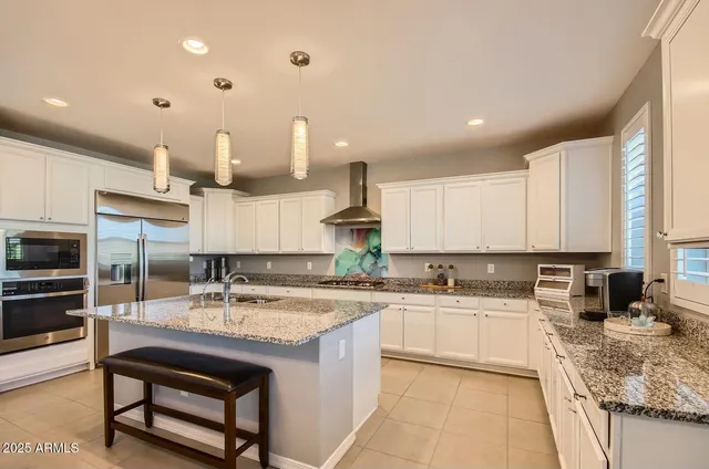 a kitchen with a sink stainless steel appliances and cabinets
