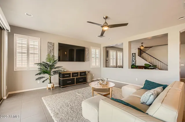 a living room with furniture and a floor to ceiling window