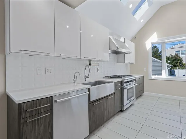 a kitchen with stainless steel appliances granite countertop a sink stove and cabinets