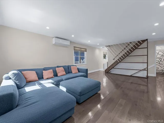 a living room with furniture and stairs