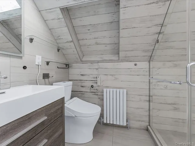 a bathroom with a toilet a sink a vanity and mirror