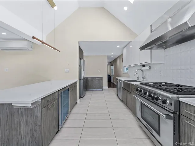 a kitchen with stainless steel appliances granite countertop a stove and a refrigerator