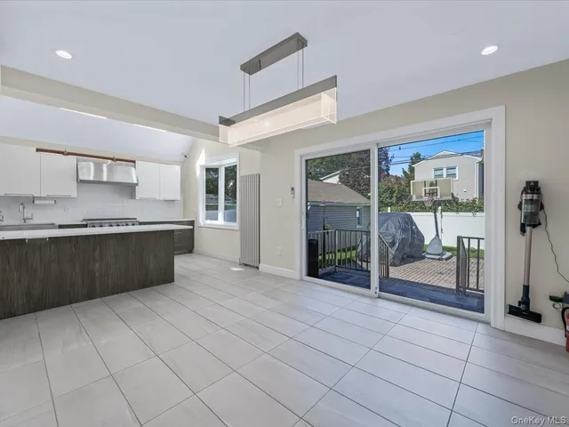 a kitchen with stainless steel appliances granite countertop a refrigerator and wooden cabinets