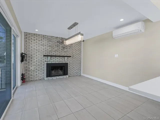 a view of an empty room with a fireplace