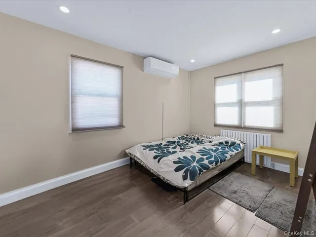 a bed sitting in a bedroom next to a window