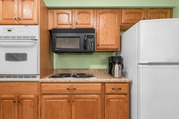 a kitchen with granite countertop cabinets and black appliances