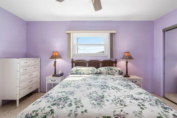 a bedroom with a bed and a dresser