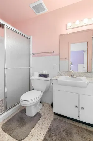 a bathroom with a sink toilet and shower