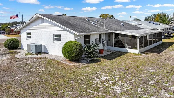 a view of a house with a yard and sitting area