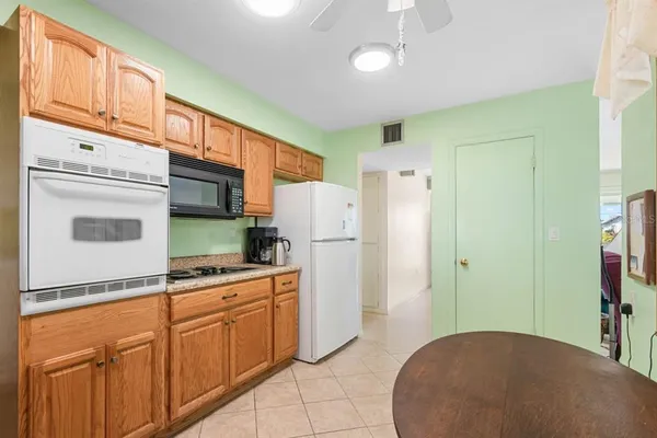 a kitchen with cabinets and a refrigerator