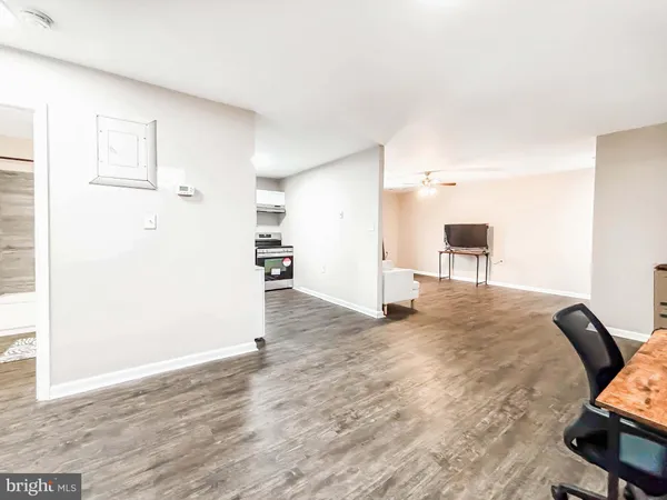 a view of a workspace with furniture and wooden floor