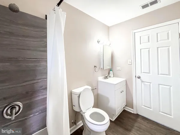 a bathroom with a sink toilet vanity and tub
