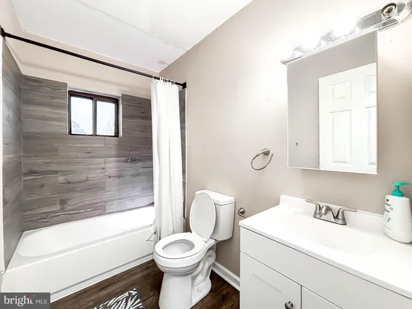 a bathroom with a sink toilet vanity and tub