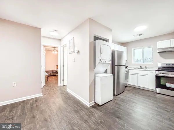 a kitchen with a refrigerator sink and cabinets