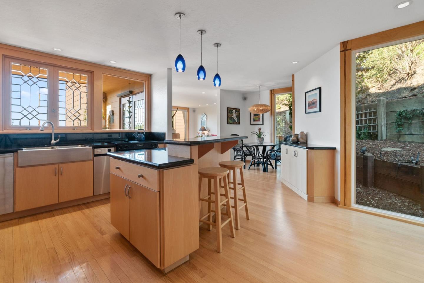 7625 Oak Ridge Road Aptos, CA 95003 - Photo 18 of 67 a kitchen with stainless steel appliances granite countertop a stove top oven a sink a dining table and chairs