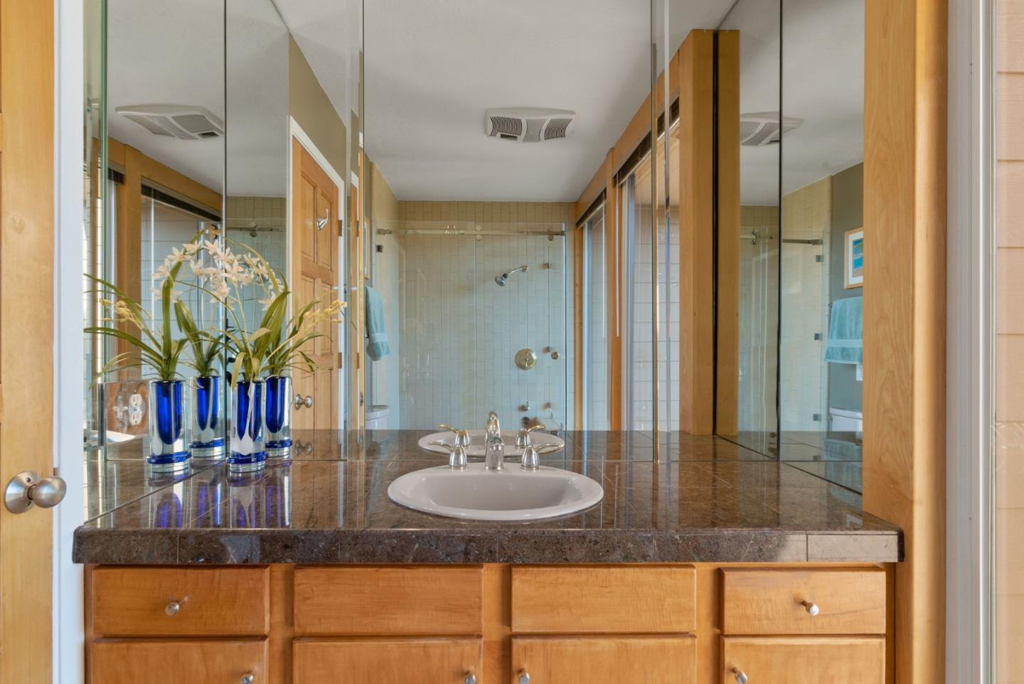 7625 Oak Ridge Road Aptos, CA 95003 - Photo 40 of 67 a bathroom with a granite countertop sink a mirror and shower