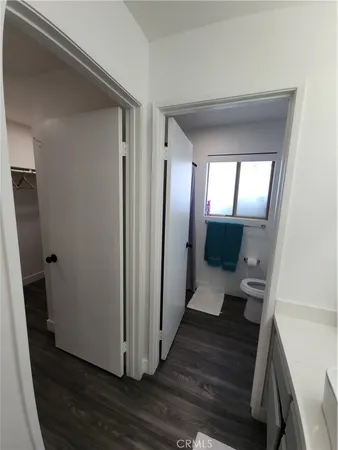 a view of a hallway view with wooden floor and staircase