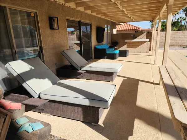 a balcony with table and chairs