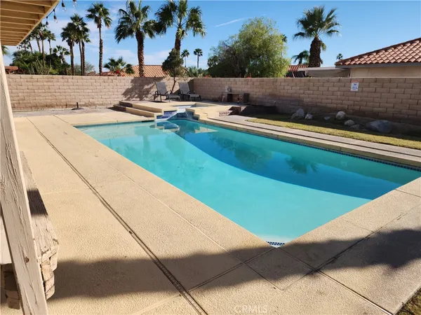 a view of swimming pool with a lounge chair