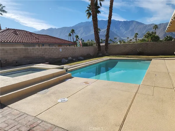 a view of swimming pool with outdoor seating and plants