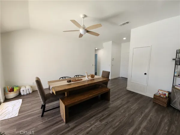 a view of a workspace with furniture and wooden floor