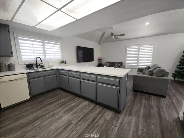 a kitchen with a sink a window and chairs