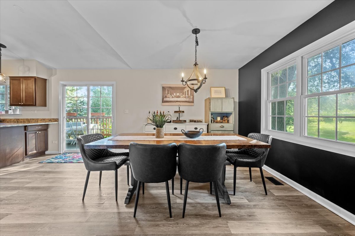 2-n651 Beith Road Elburn, IL 60119 - Photo 11 of 24 a view of a dining room with furniture window and wooden floor