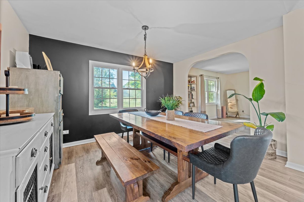 2-n651 Beith Road Elburn, IL 60119 - Photo 12 of 24 a view of a dining room with furniture window and wooden floor