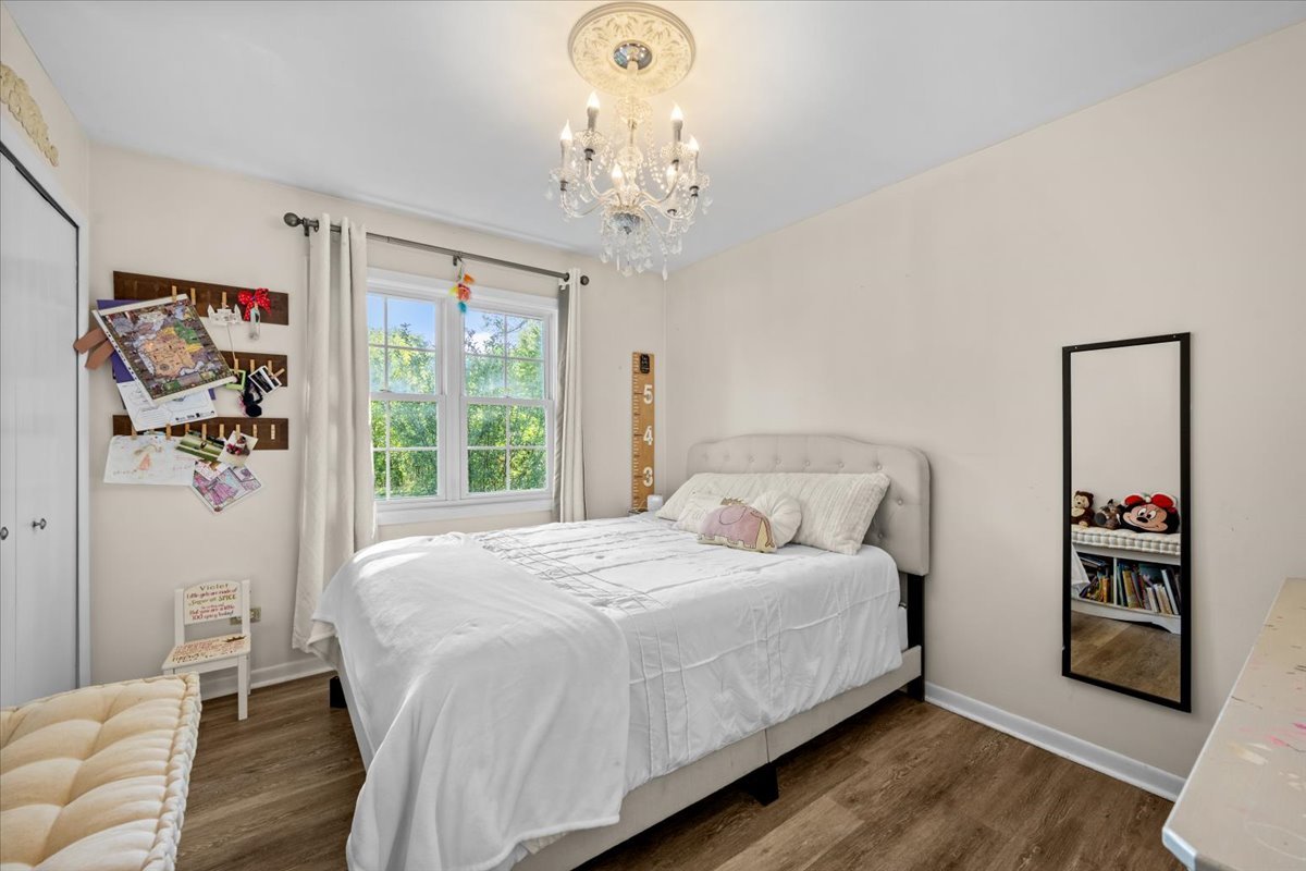 2-n651 Beith Road Elburn, IL 60119 - Photo 16 of 24 a bedroom with a large bed and a chandelier