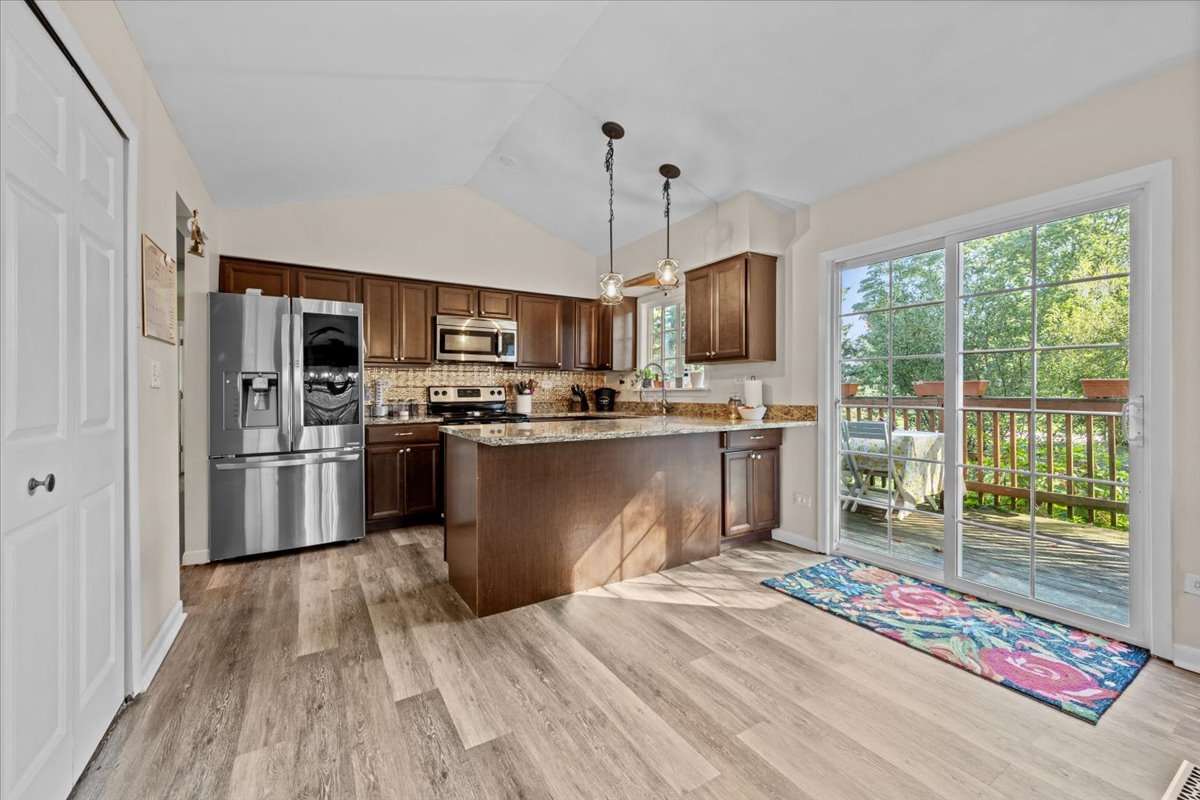 2-n651 Beith Road Elburn, IL 60119 - Photo 10 of 24 a kitchen with stainless steel appliances granite countertop a refrigerator a stove top oven a sink dishwasher a refrigerator and white cabinets with wooden floor