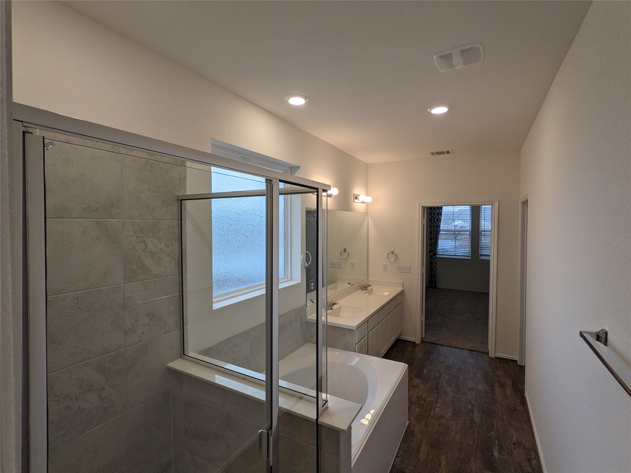 100 Montauk Loop Georgetown, TX 78628 - Photo 9 of 21 Indulge in a tranquil retreat featuring a spacious shower and dual vanities, offering a seamless flow to the adjacent room.