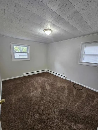 an empty room with a empty space and windows