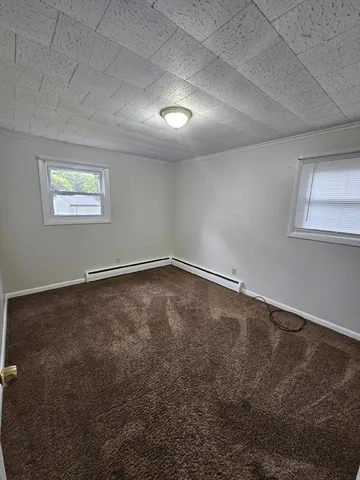 an empty room with a empty space and windows