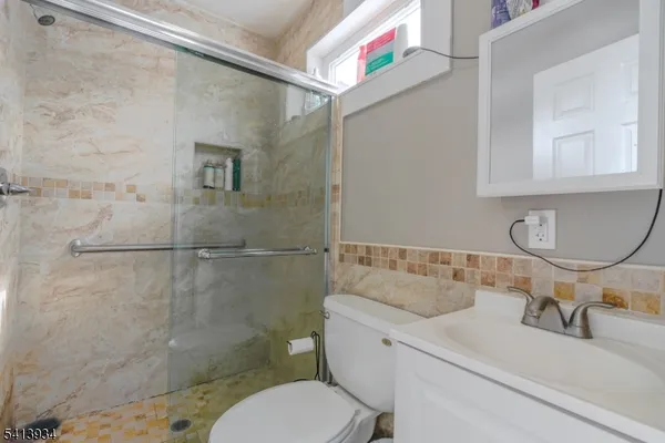 a bathroom with a sink toilet and shower