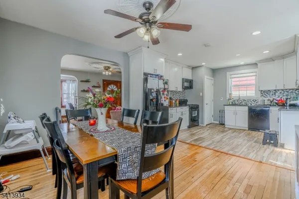 a view of a dining room with furniture and a kitchen view