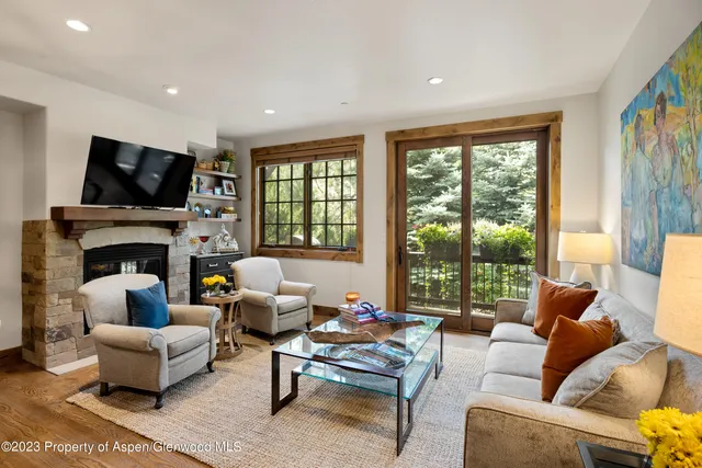 a living room with fireplace furniture and a flat screen tv