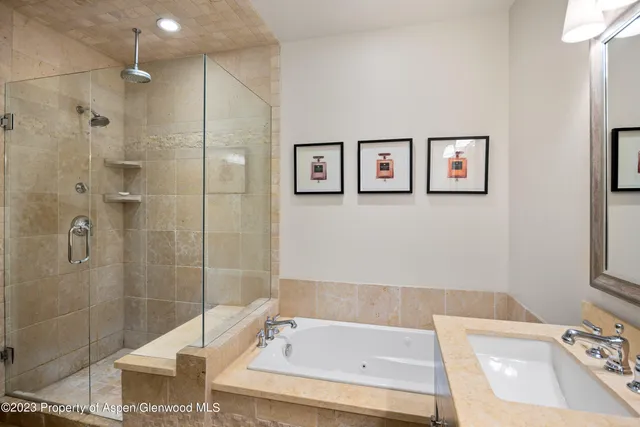 a bathroom with a tub sink and shower