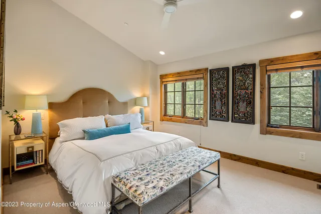 a bedroom with a large bed and a window