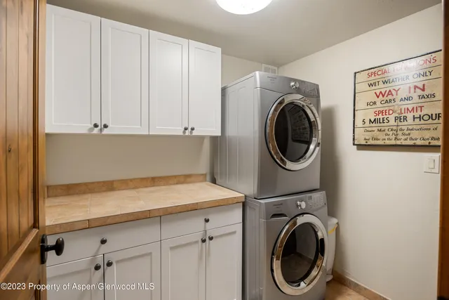 a utility room with sink dryer and washer