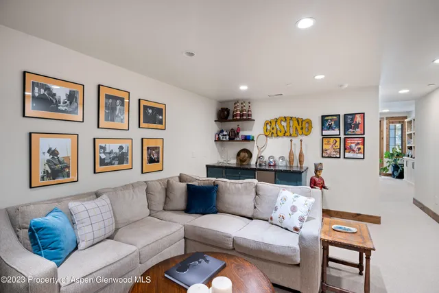 a living room with furniture and wall paintings