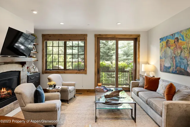 a living room with furniture fireplace and window