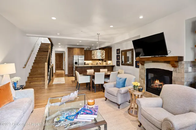 a living room with furniture fireplace and flat screen tv