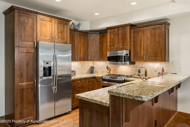 a kitchen that has a cabinets and a refrigerator