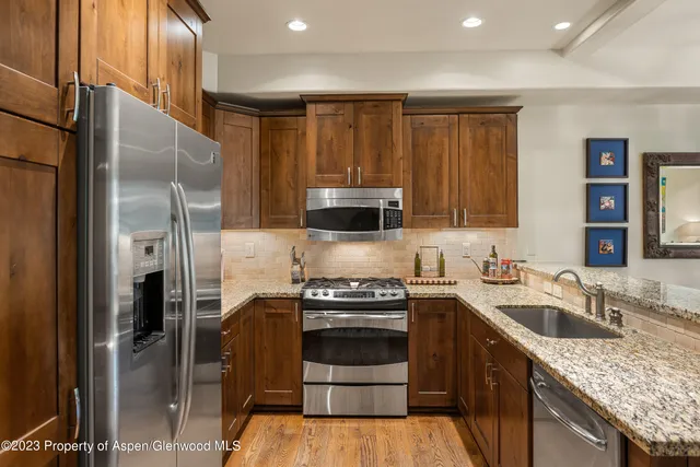 a kitchen with a sink stove and refrigerator