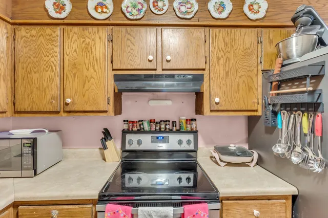a stove top oven sitting inside of a kitchen