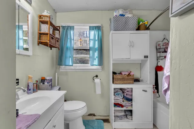 a bathroom with a toilet and a shower curtain