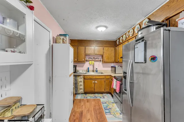 a kitchen with stainless steel appliances granite countertop a refrigerator and a stove
